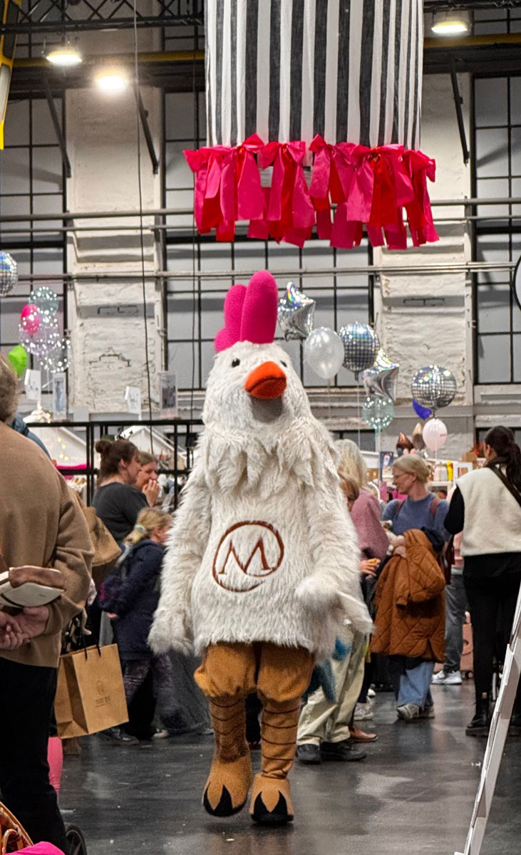 Friendly chicken mascot walking the show floor