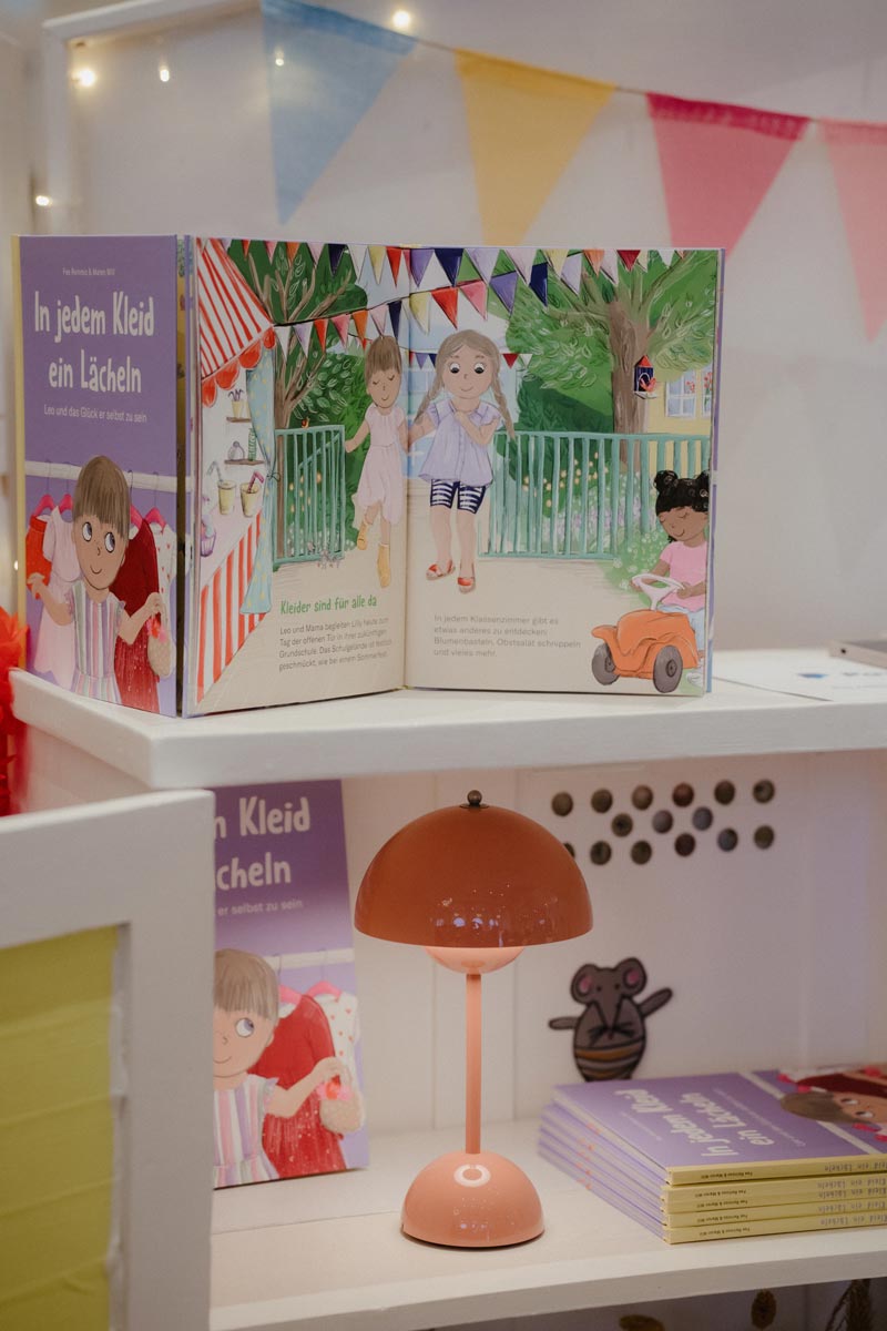 Picture book and pastel lamp styled on a shelf