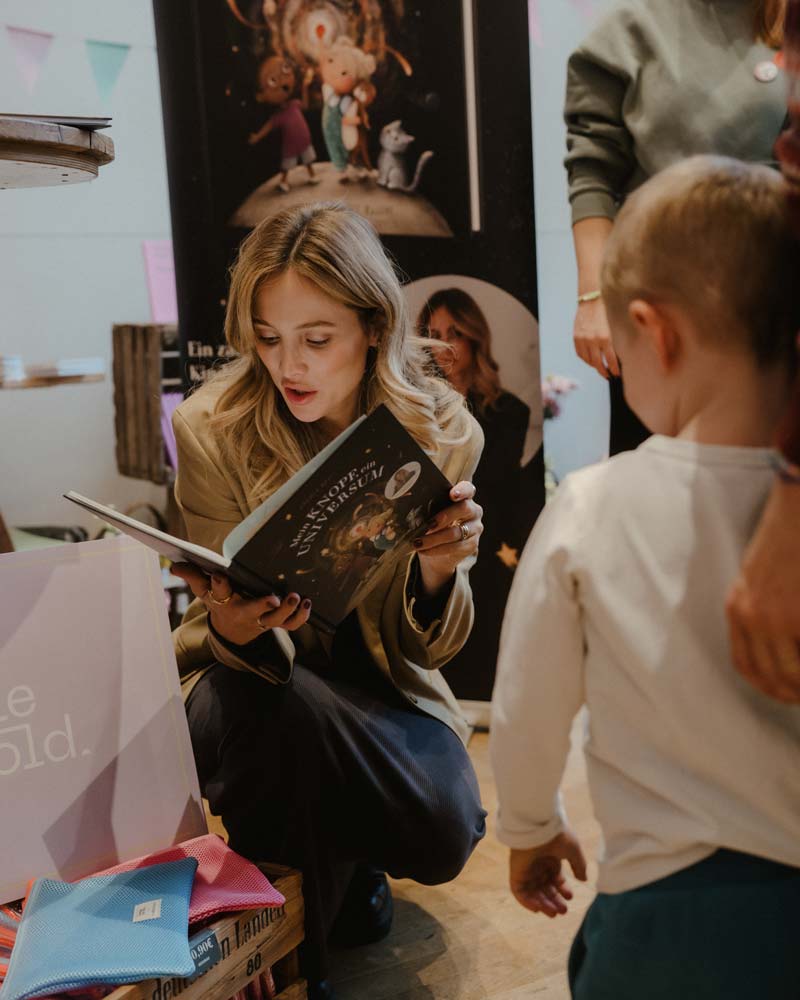 Author reading a picture book to a small child