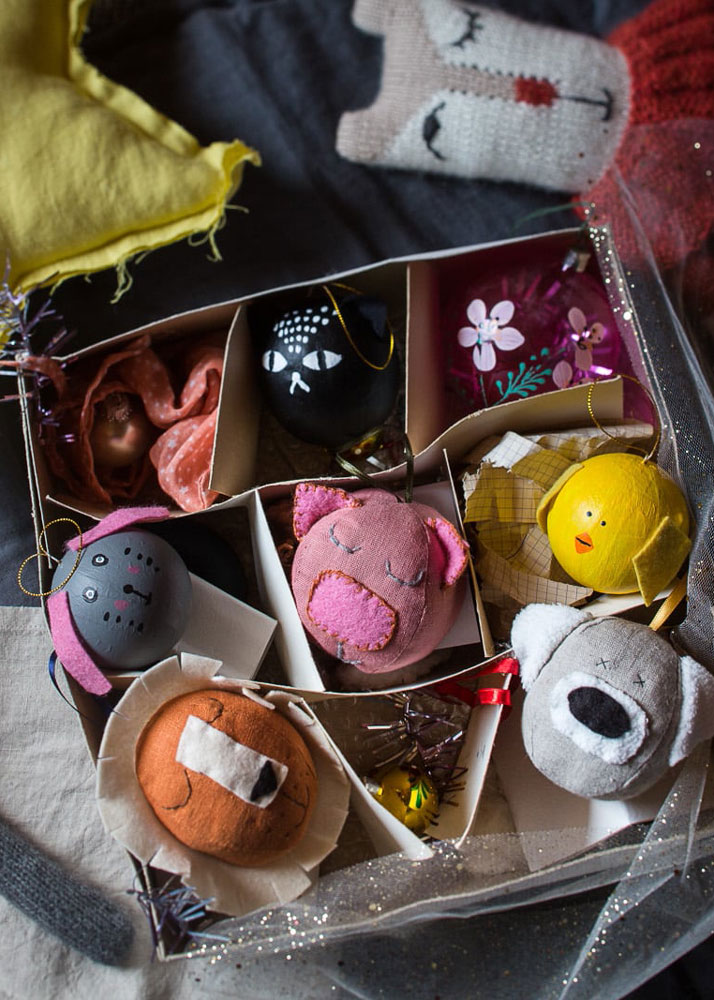 Hands presenting handmade wooden fairy-door kits