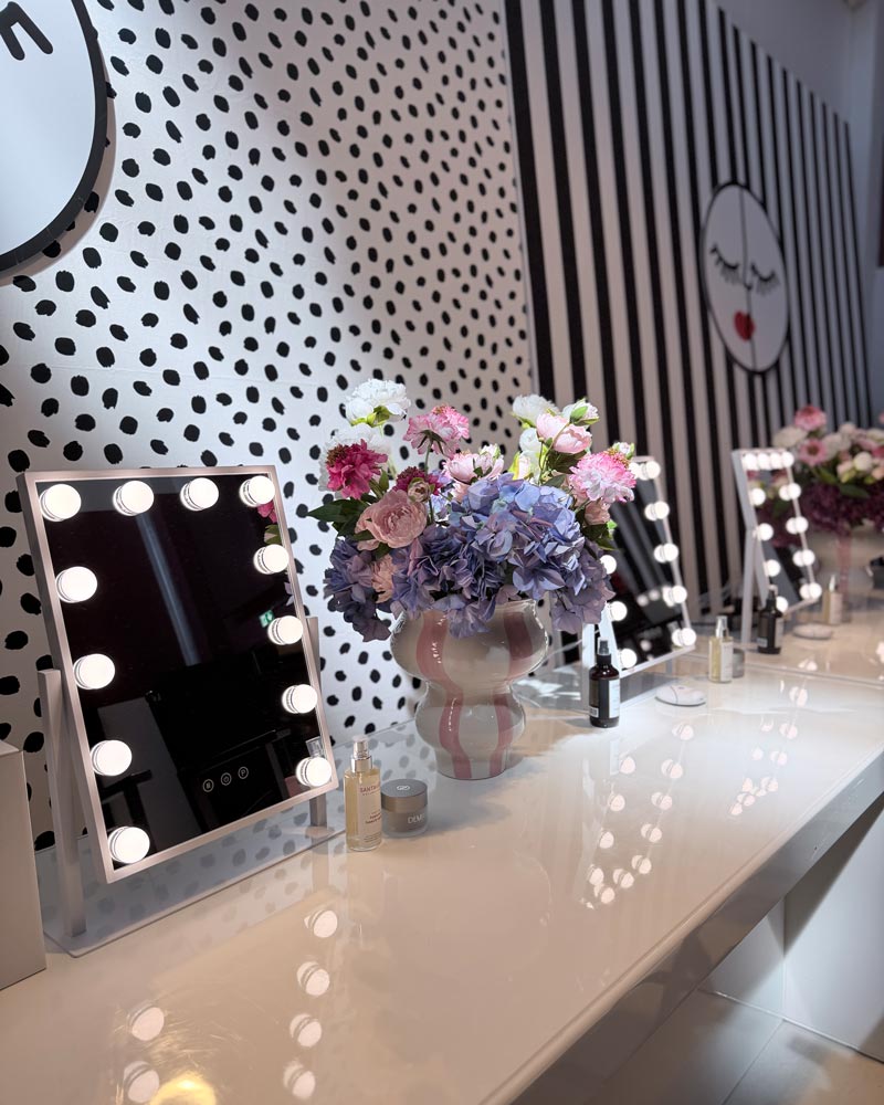 Vanity mirror station decorated with red ribbon and the Family Circle face logo